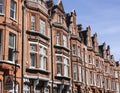 A wall of redbricked houses in London on a sunny day. Royalty Free Stock Photo