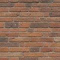 A wall of reddish-brown bricks arranged in a staggered pattern with grayish mortar. Royalty Free Stock Photo