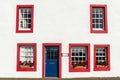 Wall of a residential historic building with a door and five windows, in St Monans village in Scotland