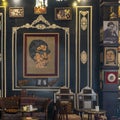 A wall in a restaurant with a mosaic portrait and pictures of Umm Kulthum in the Qasaba of Radwan Bey souk in Cairo, Egypt. Royalty Free Stock Photo