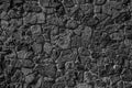 Wall of rough boulders black and white image. Stone masonry
