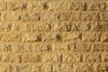 Wall with rough brickwork. Masonry of yellow sand brick blocks. Royalty Free Stock Photo