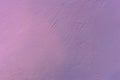 A wall with rough texture of plaster unevenly painted in purple Royalty Free Stock Photo