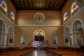 Wall with a round stained glass window inside the Catholic Cathedral