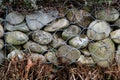 A wall of round stones held by metal mesh Royalty Free Stock Photo