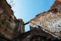Wall of ruined house at sky background, old building demolished by earthquake or other natural disaster