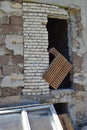 Wall of ruined industrial building and old derelict furniture - detail