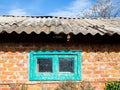 wall of rustic brick barn with dirty small window