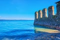 The wall of Scaligero Castle in waters of Lake Garda, Sirmione, Italy Royalty Free Stock Photo