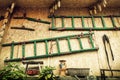 The wall of shed with ladders, various tools and dried corn