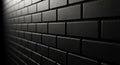 Close-up of a dark gray brick wall with sharp edges and a textured surface receding into darkness with dramatic lighting Royalty Free Stock Photo