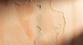 Close up textured terracotta colored plaster wall with rough surface and subtle shadows creating depth and abstract Royalty Free Stock Photo