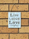 Wall sign saying `live laugh love everyday`