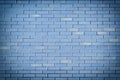 Wall of small blue bricks. The texture of the brickwork. Empty background with vignette. Royalty Free Stock Photo