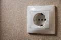 Wall socket, white electric socket on wallpaper background Royalty Free Stock Photo