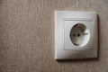 Wall socket, white electric socket on wallpaper background Royalty Free Stock Photo