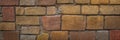 A wall of stone blocks. A wall or floor made of colorful stones of different sizes. Background Royalty Free Stock Photo