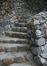 Wall of stones with a winding staircase of stone through it