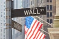 Wall Street sign and US flag in New York Royalty Free Stock Photo