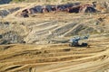 The wall surface mine with exposed colored minerals, the pit mining equipment at the bottom Royalty Free Stock Photo