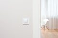 The wall switch is in the bright, contemporary interior. Open the door to the room