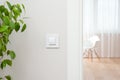 The wall switch is in the bright, contemporary interior. Open the door