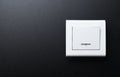 The wall switch is white on a black background. Royalty Free Stock Photo