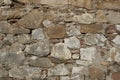 Wall texture of ancient old brick stone. Outdoor exterior castle facade with destroyed uneven pattern of shabby rock. Solid wall Royalty Free Stock Photo