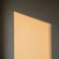 A wall with a textured surface displays a rectangular patch of light Royalty Free Stock Photo