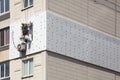 Wall Thermal insulation, industrial climbing, high-altitude work, insulation of walls with foam plastic or Styrofoam.