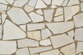 Wall tiled with pieces of polished gray stone, texture for background