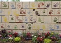 Wall of tiles made by children, Front of the Oklahoma City National Memorial & Museum, with flowers in foreground