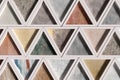 Wall with triangles of different materials in white frames Royalty Free Stock Photo