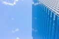 The wall of an urban building shows a blue sky