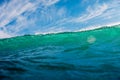 Wall of wave in ocean. Breaking turquoise wave with sun light