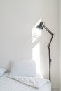 Wall white bedroom bed, pillow and fresh linens. Vertical. Royalty Free Stock Photo