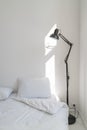 Wall white bedroom bed, pillow and fresh linens. Vertical. Royalty Free Stock Photo