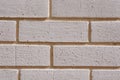 Wall of white bricks with yellow fugue