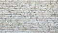 A wall of white textured brick with vertical stripes. The building background is made of white shabby brickwork Royalty Free Stock Photo