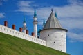 Wall and white tower of the Kazan Kremlin. Behind the tower are visible minarets of the mosque Royalty Free Stock Photo