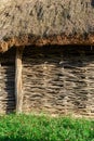 A wall of wicker twigs and a roof of reeds. Old rural building.