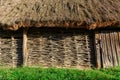 A wall of wicker twigs and a roof of reeds. Old rural building.