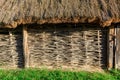 A wall of wicker twigs and a roof of reeds. Old rural building.