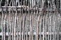 Wall of willow twigs as background. Rural old fence, made from willow tree twigs and branches. Royalty Free Stock Photo