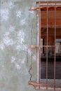 Wall and window with steel grids at an abandoned building