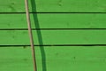 Wood planks painted in green, shadow