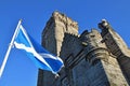 Wallace Monument in Stirling, Scotland with Scottish flag flying in foreground.