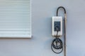 Wallbox on a family house wall for comfortable charging of electric car