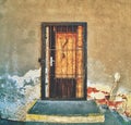 Walled door entry of abandoned house. Broken iron bars Royalty Free Stock Photo