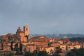 Walled hilltop village lit by sun's first rays